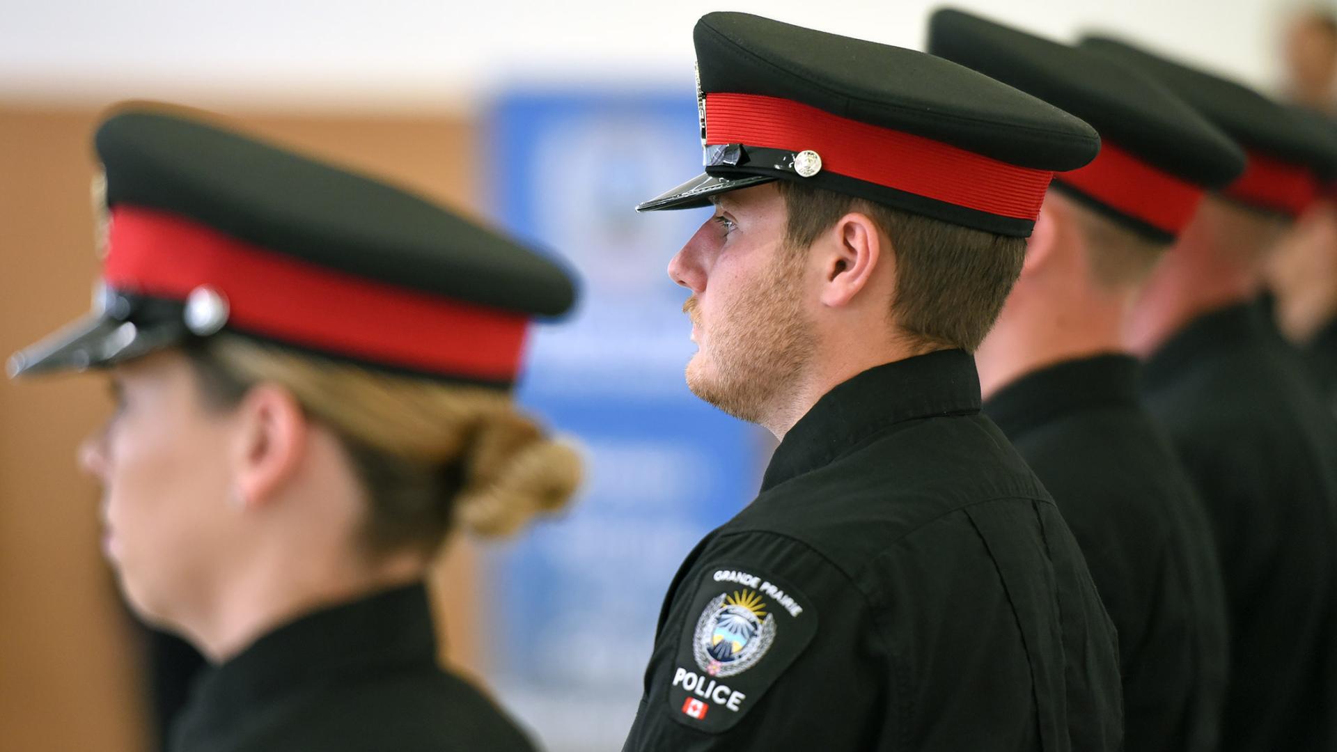 Grande Prairie Police Service members stand during a graduation ceremony