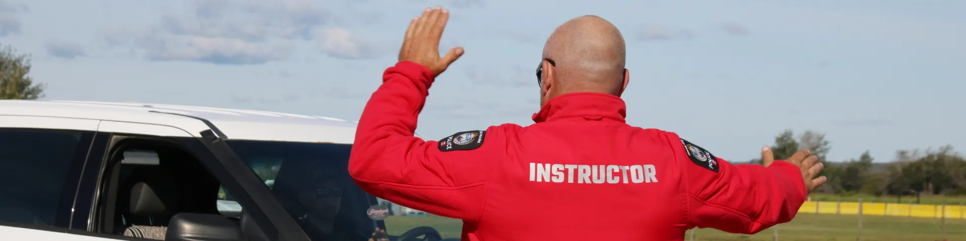 A GPPS trainer directing a vehicle during EVOC training